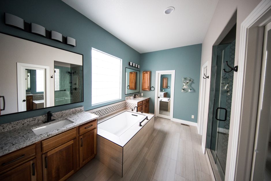 Bathroom remodeling contractor reviewing plans in a renovated space