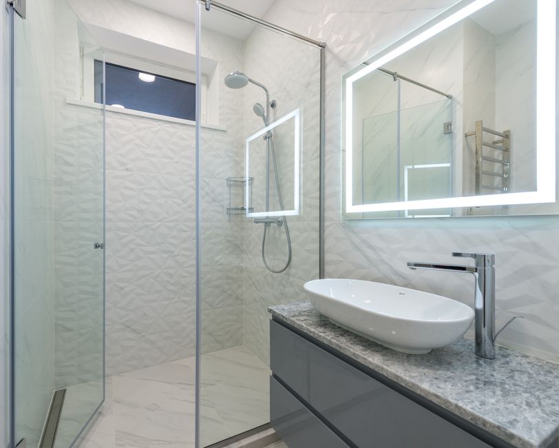Modern walk-in shower with sleek glass doors and elegant tile